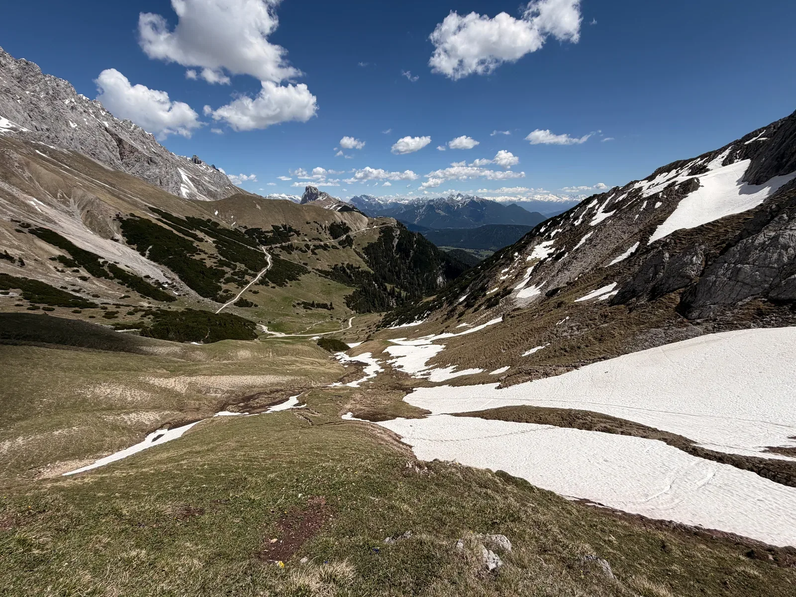 Open mountain basin with snowfields and clearly visible trail line, Zugspitz Ultratrail 107K.
