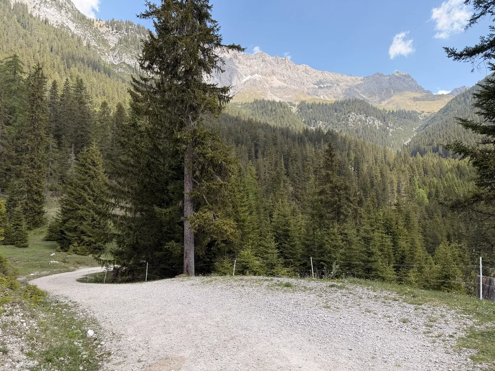 Gravel road in an alpine valley during the long descent, ZUT 107K at KM 41.2.