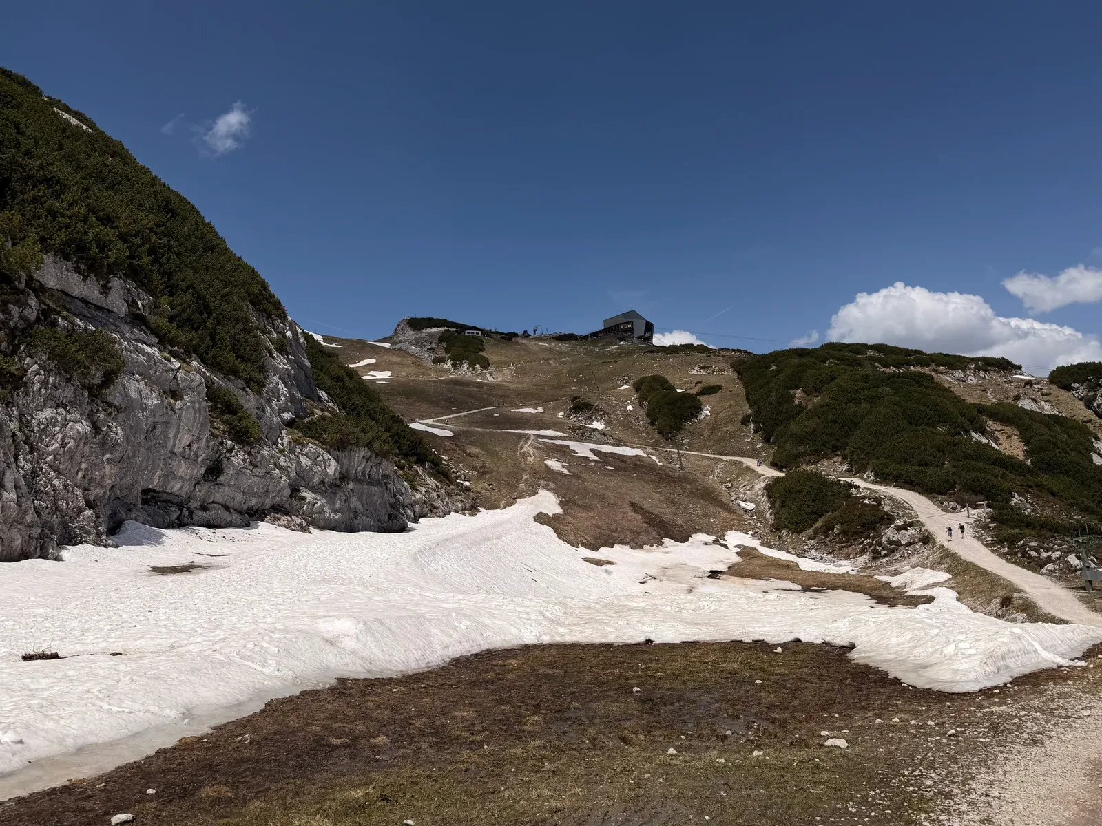 Snow patches and gravel in alpine terrain above the treeline, ZUT 107K at KM 92.3.